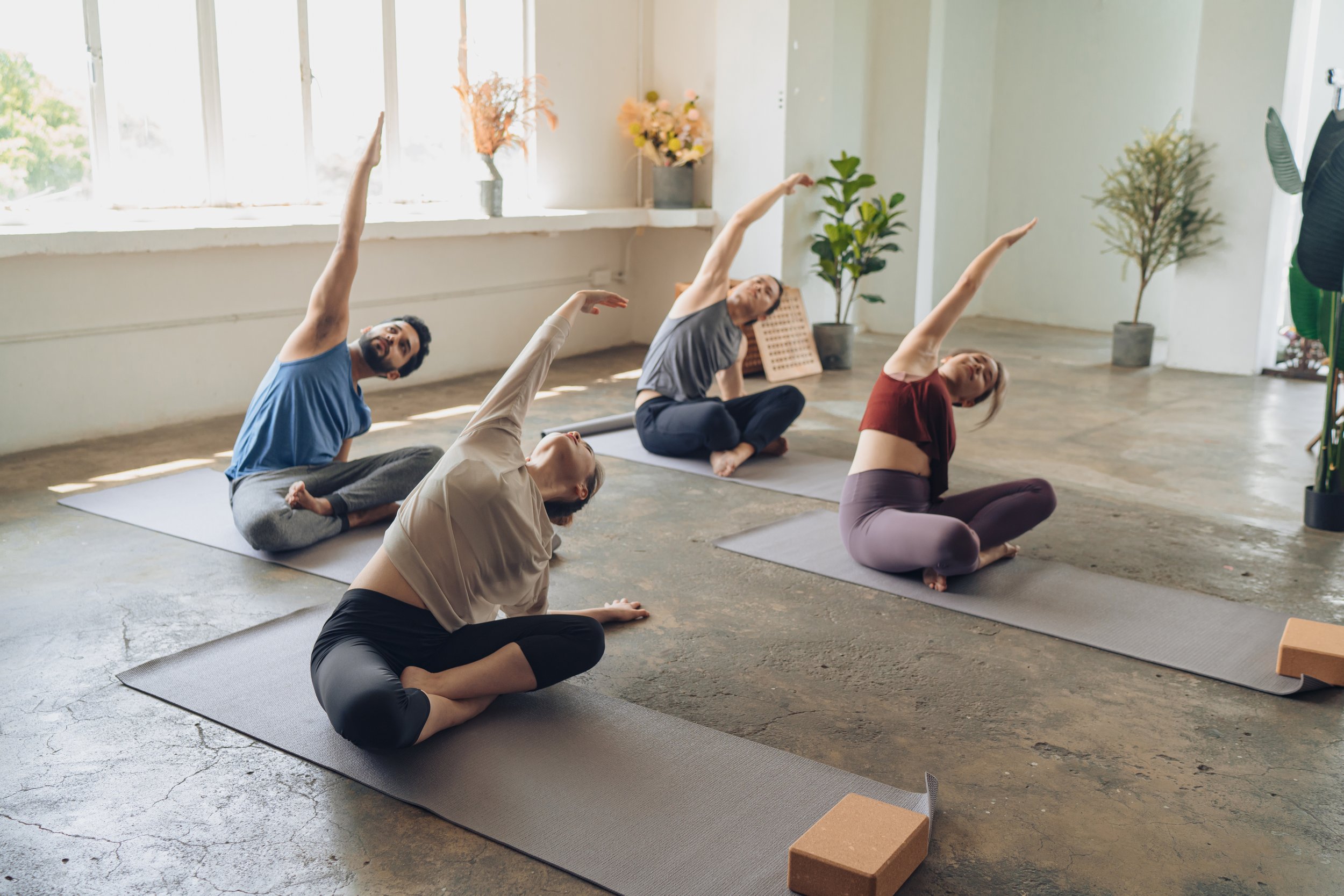 Group of people stretching in a yoga class